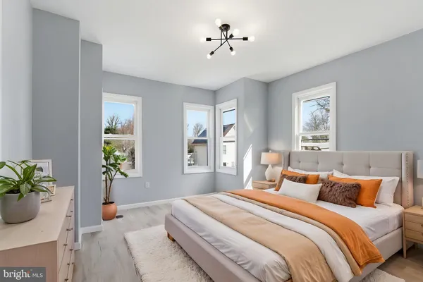 a bedroom with bed and wooden floor
