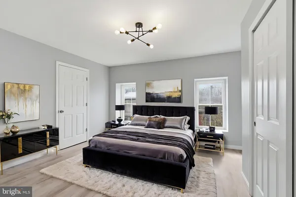 a bedroom with a bed and a chandelier