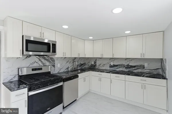 a kitchen with a sink stove and microwave