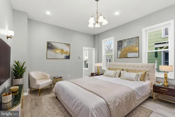 a bedroom with a bed and a chandelier