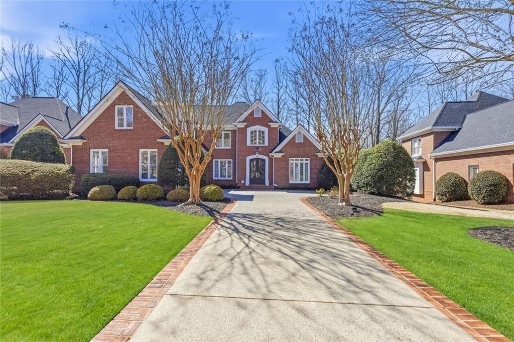3165 Wolf Willow Cl Milton, GA 30004 - Photo 1 of 1 a front view of a house with yard