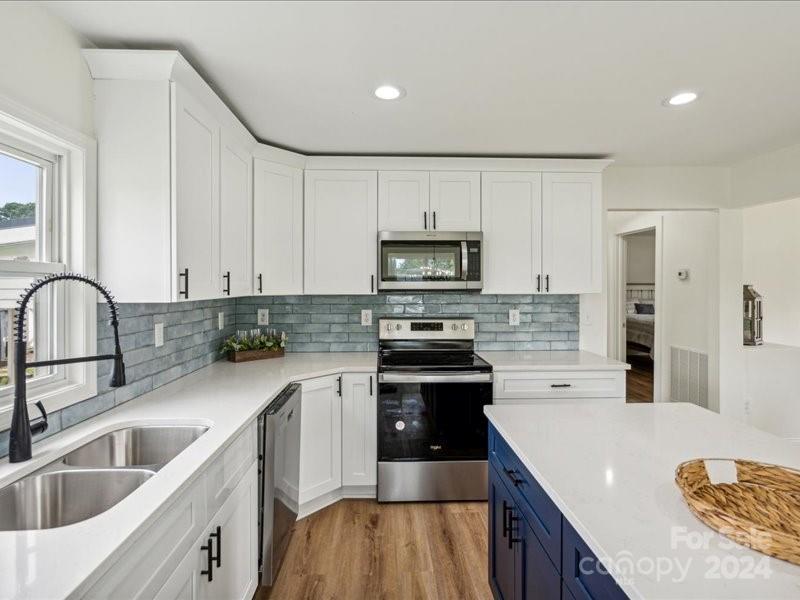 236 1st Street South Fort Mill, SC 29708 - Photo 8 of 23 a kitchen with stainless steel appliances granite countertop a sink stove and refrigerator