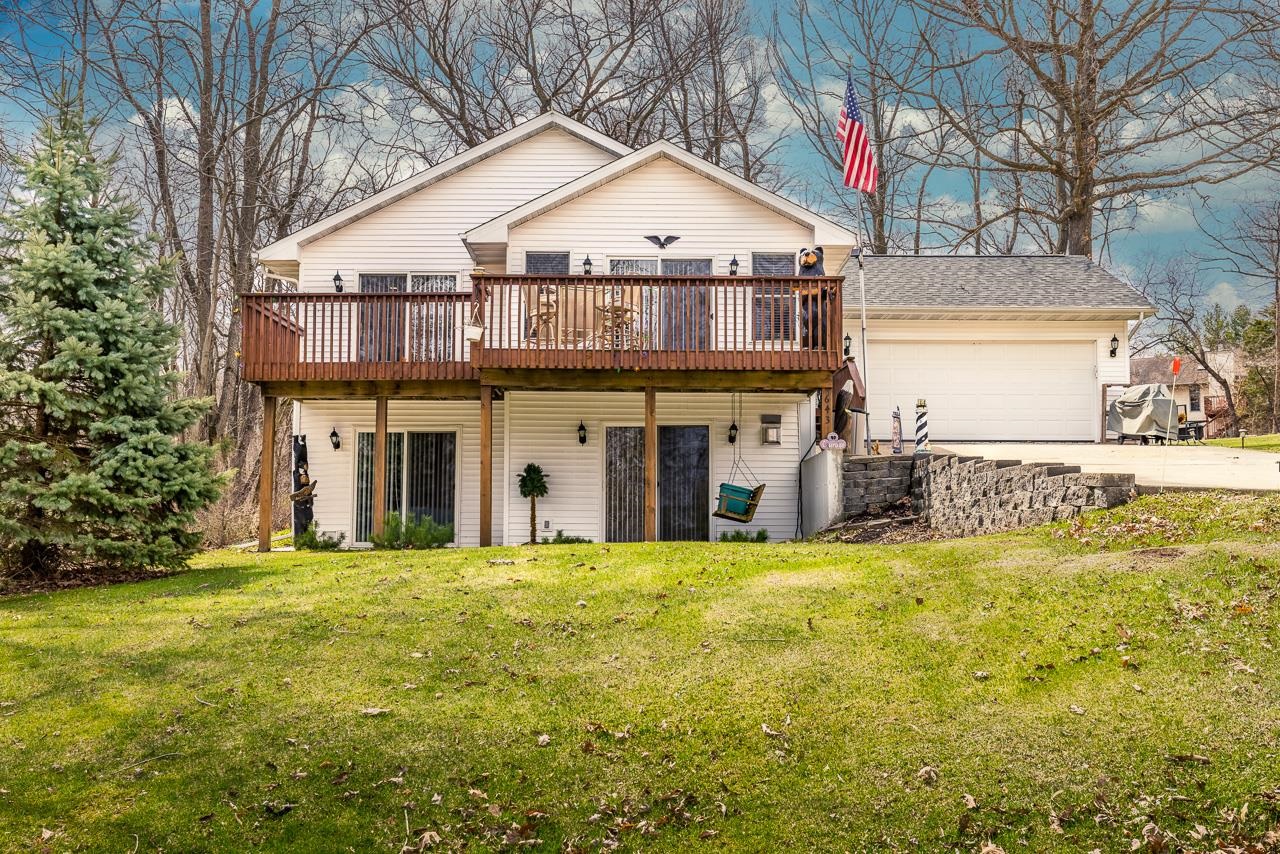 a view of a house with a yard and sitting area