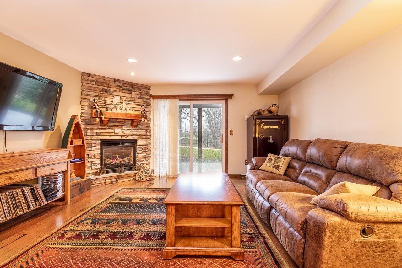643 Knollwood Road Davis, IL 61019 - Photo 15 of 26 a living room with furniture a flat screen tv and a fireplace