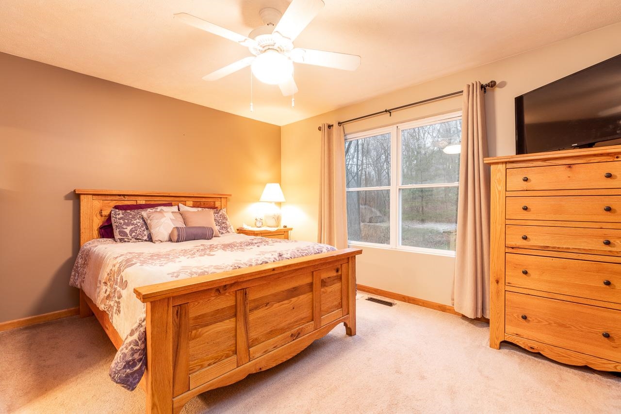 643 Knollwood Road Davis, IL 61019 - Photo 9 of 26 a bedroom with a bed and a flat tv screen on dresser