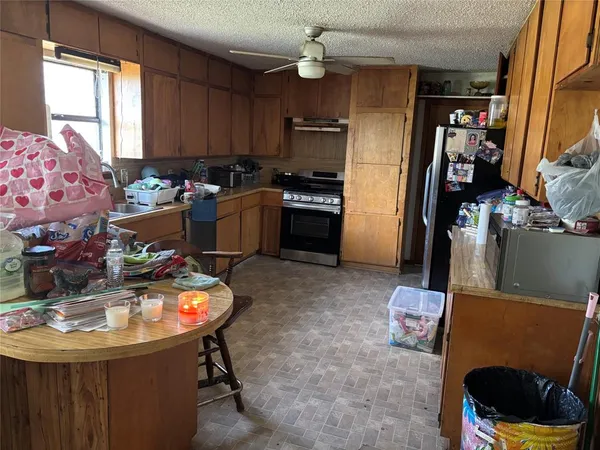 a kitchen with sink refrigerator and window