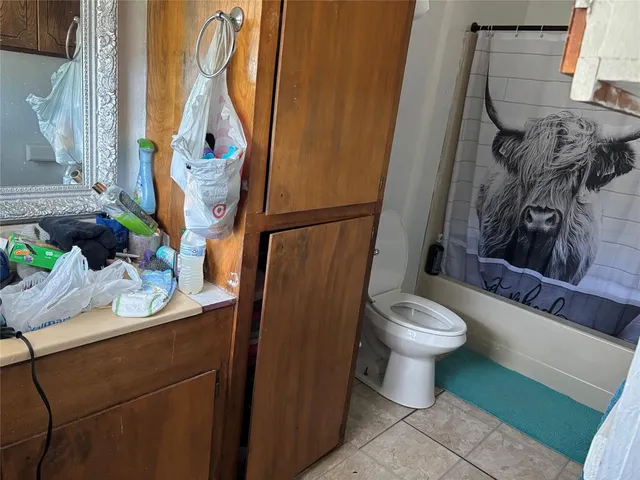 a bathroom with a toilet sink and shower