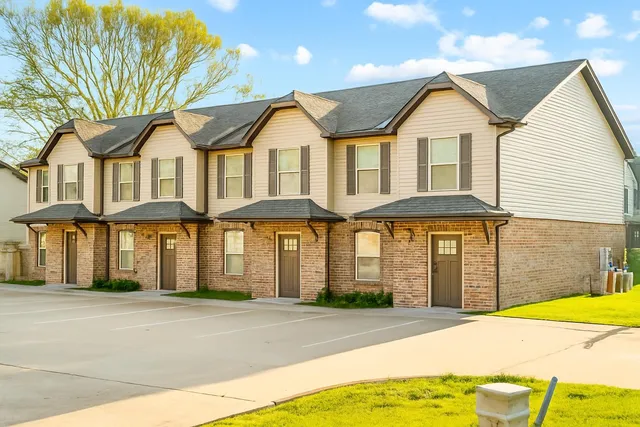 a front view of a residential houses with yard