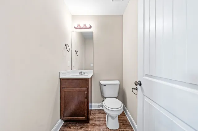 a view of a hallway with white walls and door