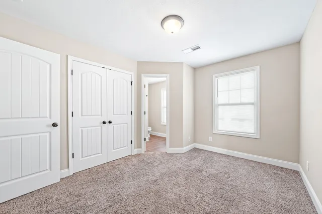 a bathroom with a granite countertop sink a toilet and shower