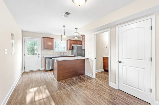 a kitchen with refrigerator sink and wooden cabinets