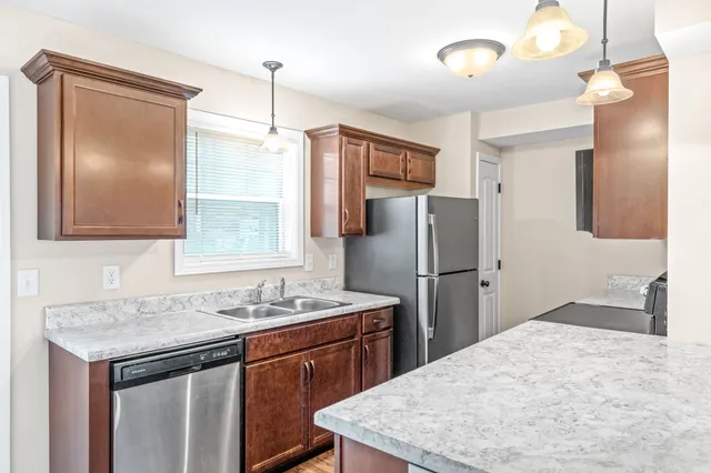 a kitchen with a sink refrigerator and microwave