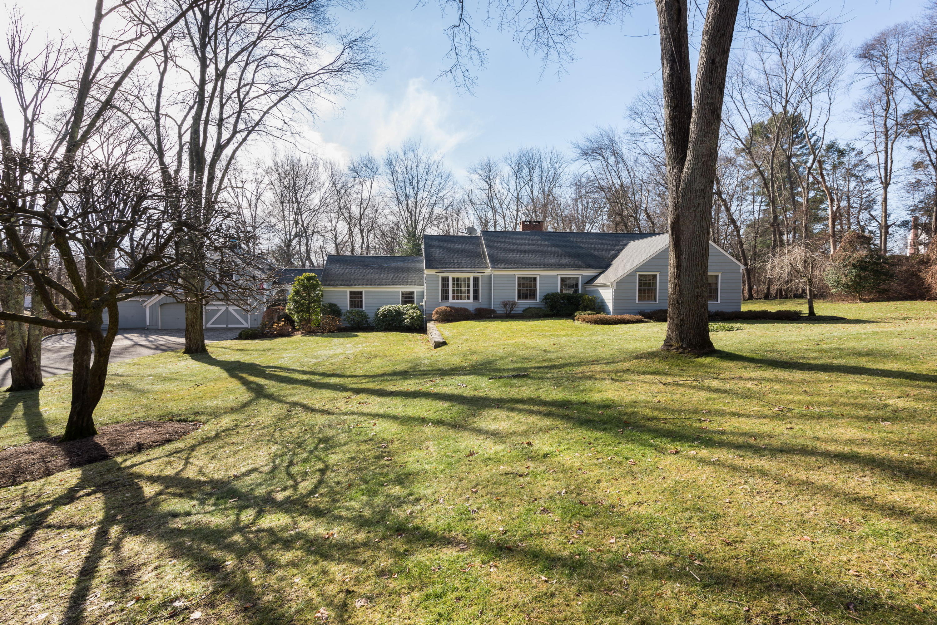 8 Priscilla Lane Darien, CT 06820 - Photo 15 of 37 a view of a swimming pool with a house in the background