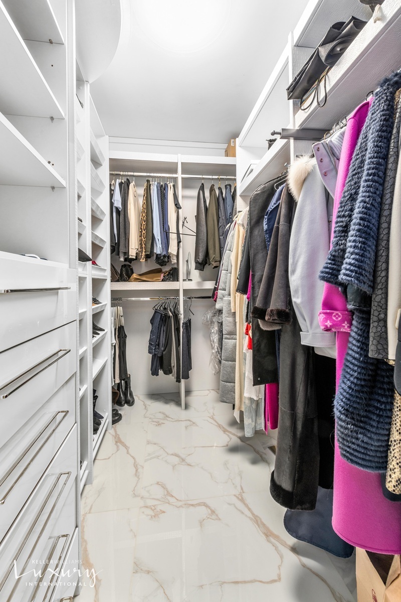 Undisclosed Address Manhattan, NY 10022 - Photo 10 of 16 a view of walk in closet with clothes and shoes