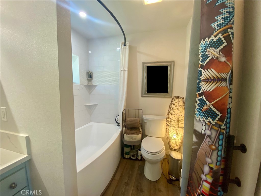 11255 Rancheria Road Upper Lake, CA 95485 - Photo 15 of 46 a bathroom with a toilet and a bathtub