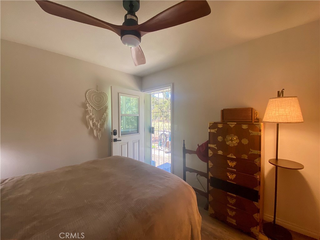 11255 Rancheria Road Upper Lake, CA 95485 - Photo 18 of 46 a bedroom with a bed and a lamp on the dresser