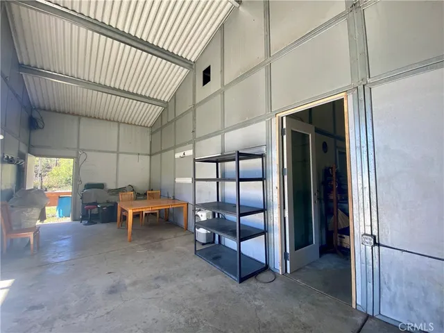a view of a field with a tree in the background