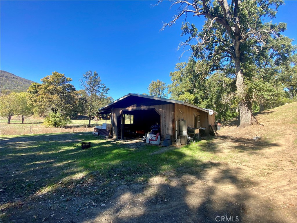 11255 Rancheria Road Upper Lake, CA 95485 - Photo 34 of 46 a view of a yard with an outdoor and a fire pit