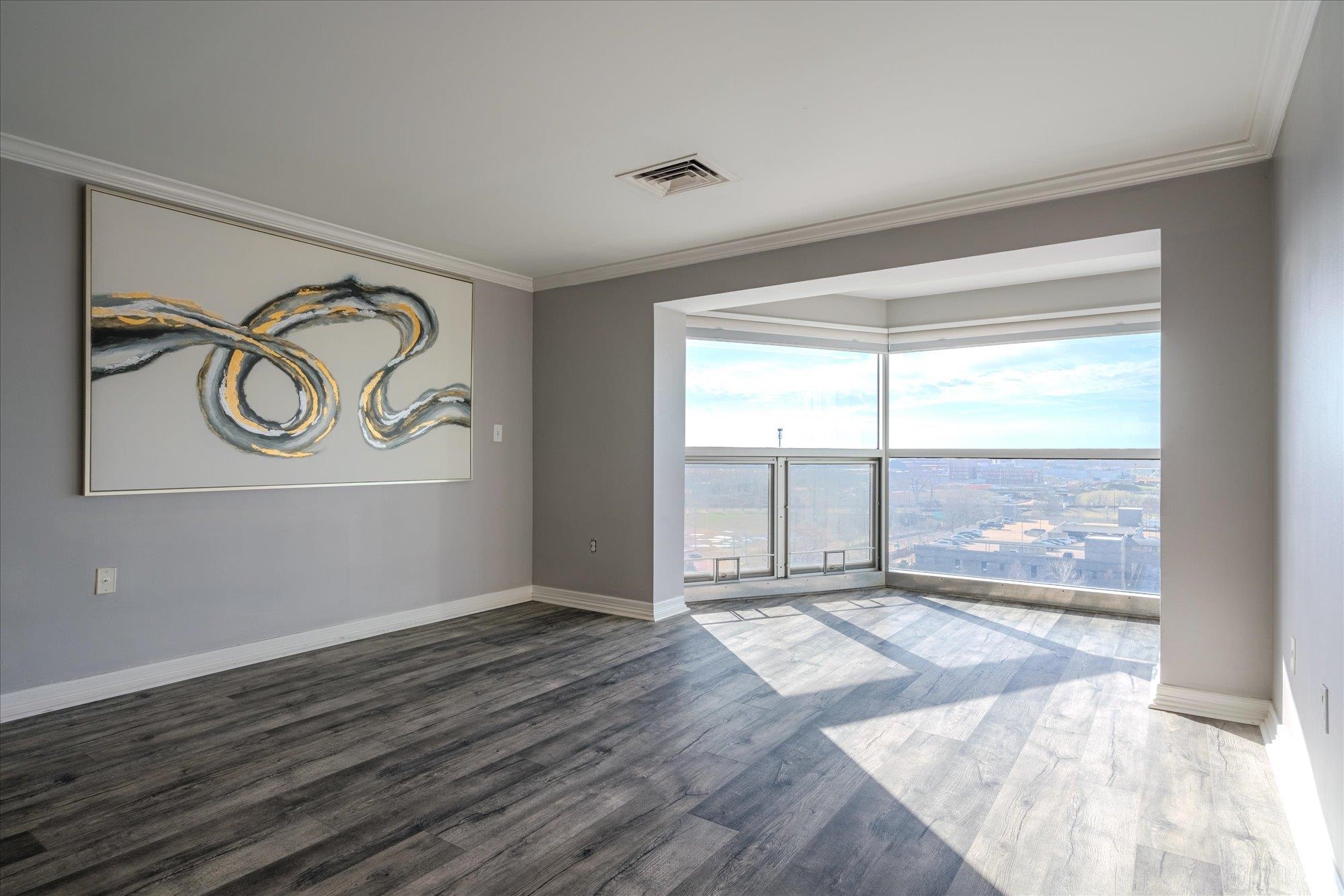 655 Riverside Drive, Unit 904B Memphis, TN 38103 - Photo 12 of 39 an empty room with wooden floor and windows