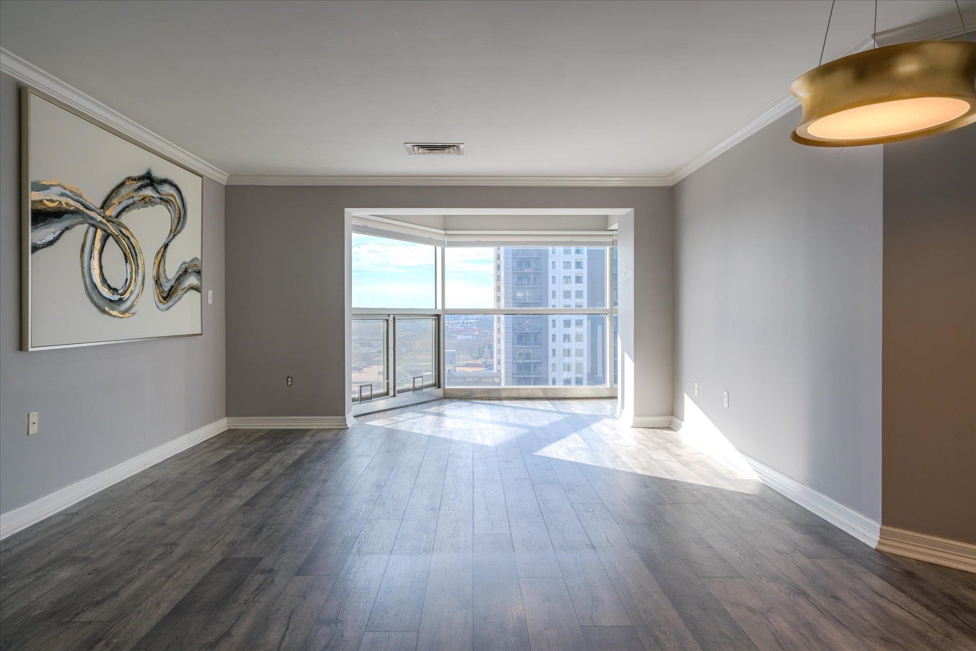 655 Riverside Drive, Unit 904B Memphis, TN 38103 - Photo 13 of 39 an empty room with wooden floor and windows