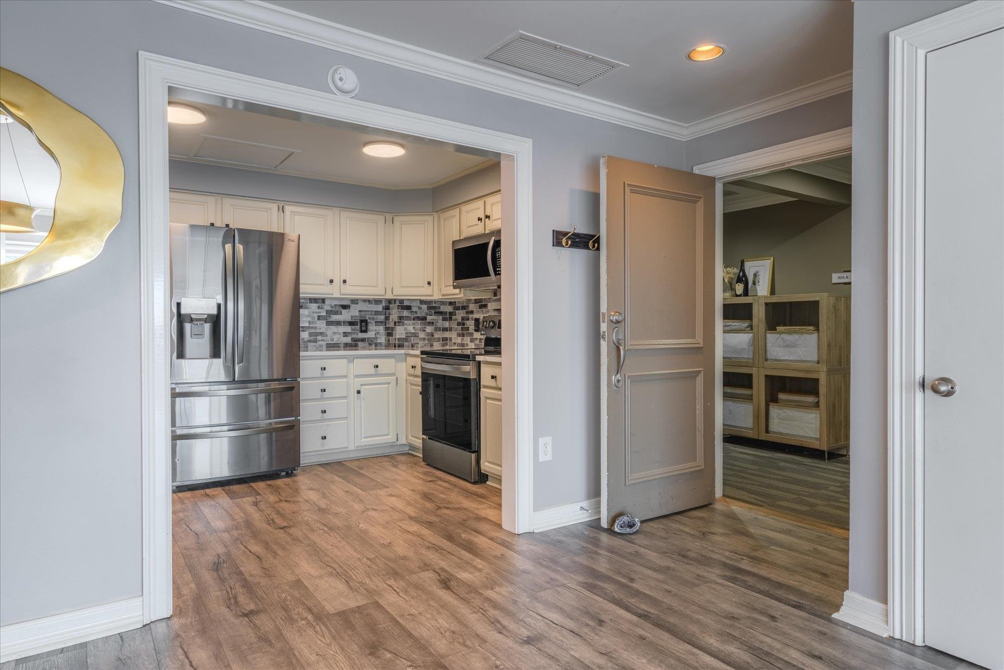 655 Riverside Drive, Unit 904B Memphis, TN 38103 - Photo 14 of 39 a kitchen with stainless steel appliances a refrigerator and a stove top oven