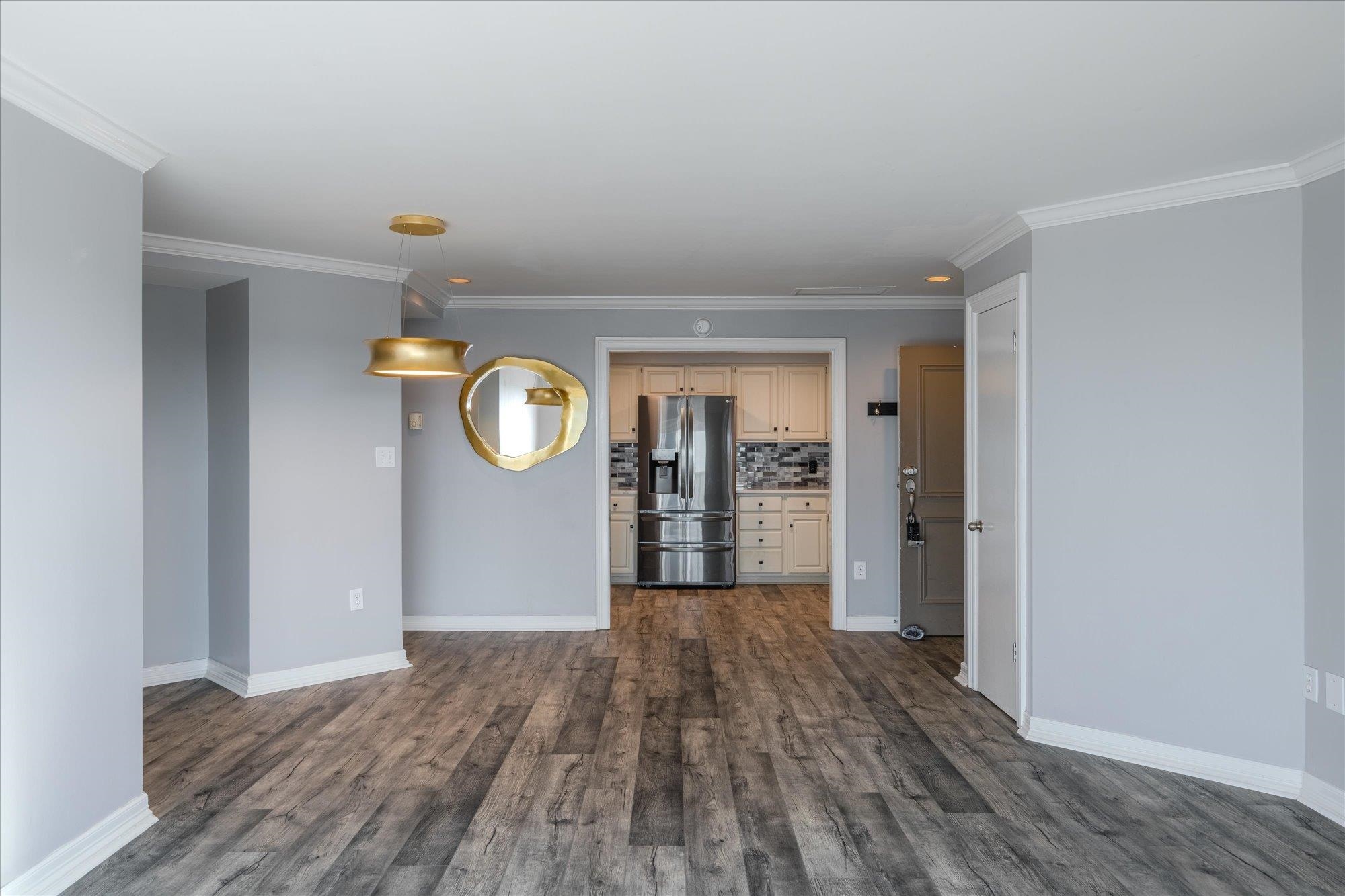 655 Riverside Drive, Unit 904B Memphis, TN 38103 - Photo 15 of 39 a view of an empty room and window and wooden floor