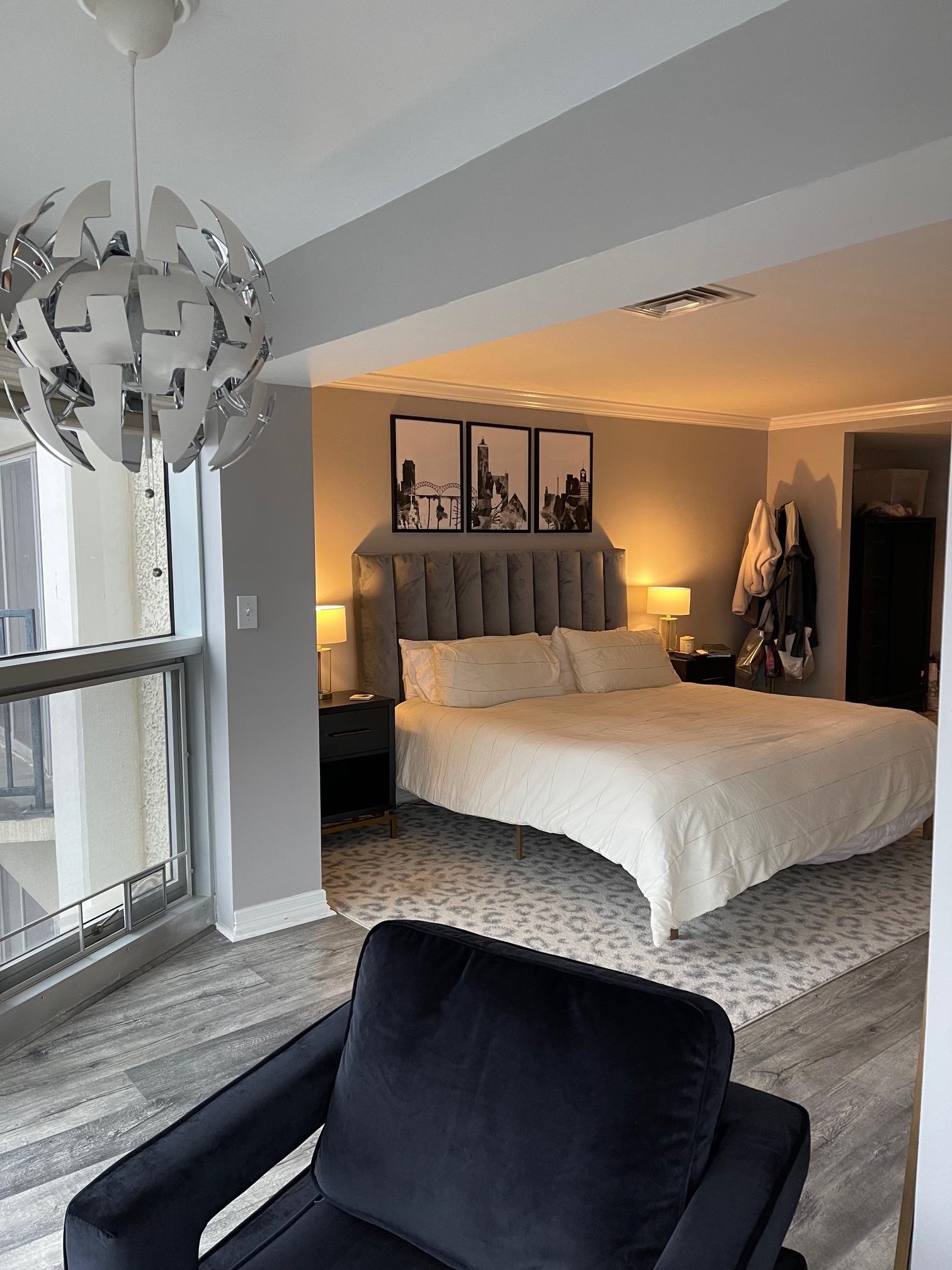 655 Riverside Drive, Unit 904B Memphis, TN 38103 - Photo 21 of 39 a bedroom with a bed and wooden floor