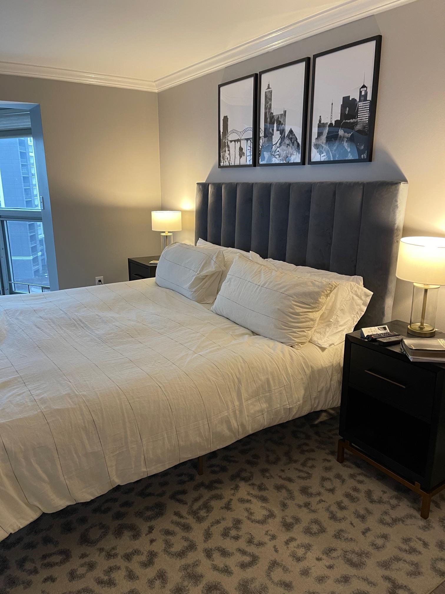 655 Riverside Drive, Unit 904B Memphis, TN 38103 - Photo 23 of 39 a bed sitting in a bedroom next to a window