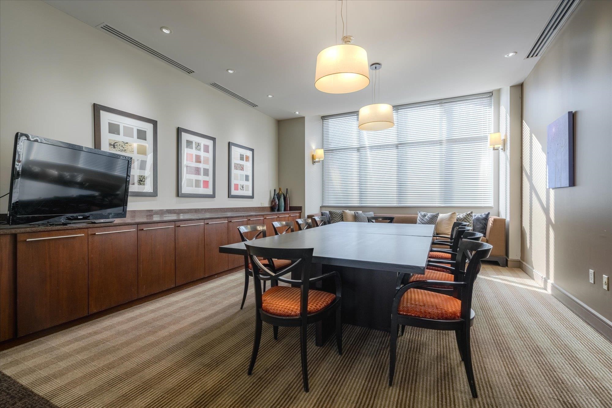 655 Riverside Drive, Unit 904B Memphis, TN 38103 - Photo 32 of 39 a view of a a dining room with furniture window and wooden floor