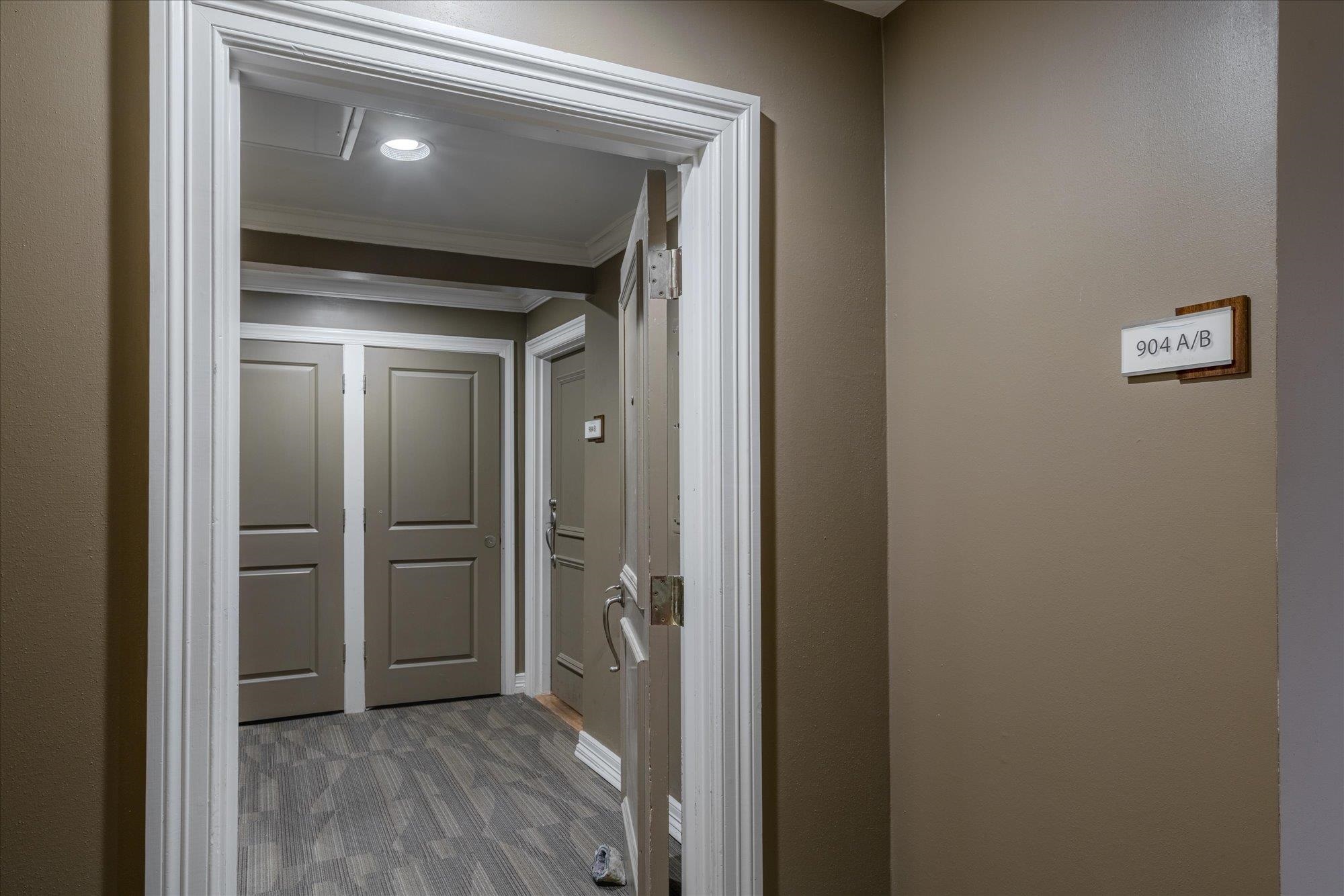 655 Riverside Drive, Unit 904B Memphis, TN 38103 - Photo 6 of 39 a view of a hallway with wooden floor