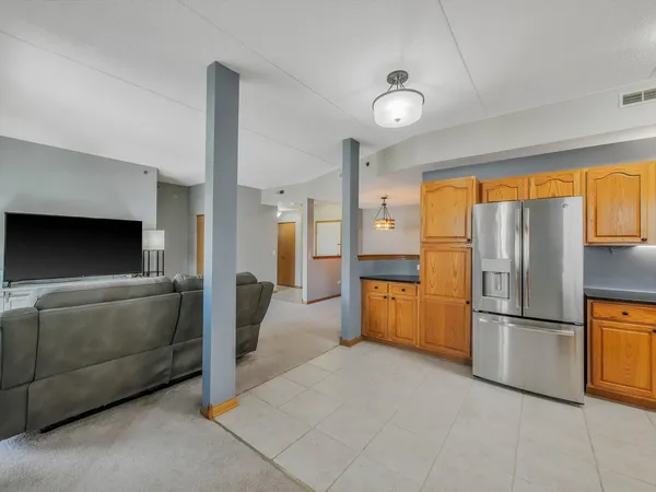 a kitchen with stainless steel appliances granite countertop a refrigerator and a stove top oven