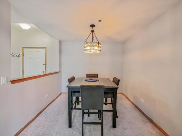 a view of a dining room with a table and chairs