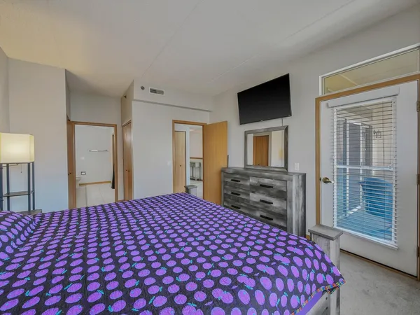 a bedroom with a large bed and a tv