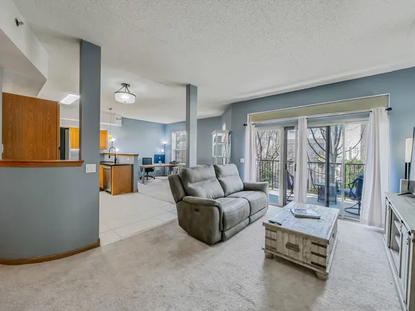 a living room with furniture and a large window