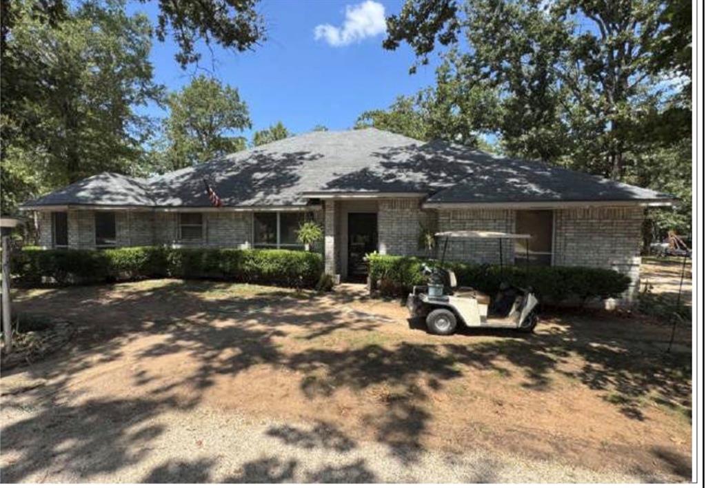 a view of a house with backyard sitting area and garden