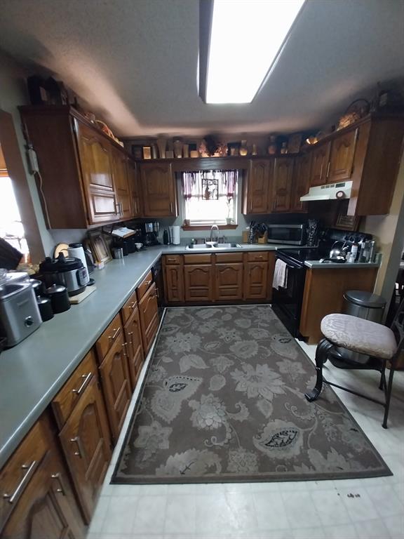 4415 Smallwood Road Reno, TX 75462 - Photo 36 of 39 a large kitchen with kitchen island granite countertop lots of counter top space and stainless steel appliances