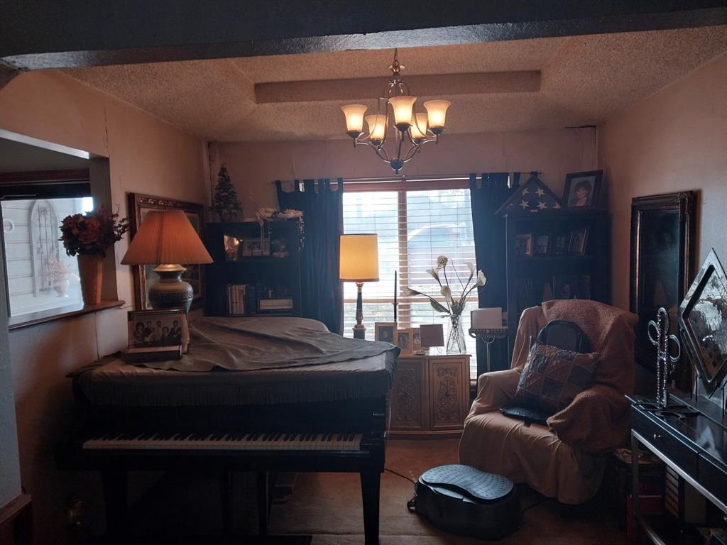 4415 Smallwood Road Reno, TX 75462 - Photo 37 of 39 a living room with furniture and a chandelier