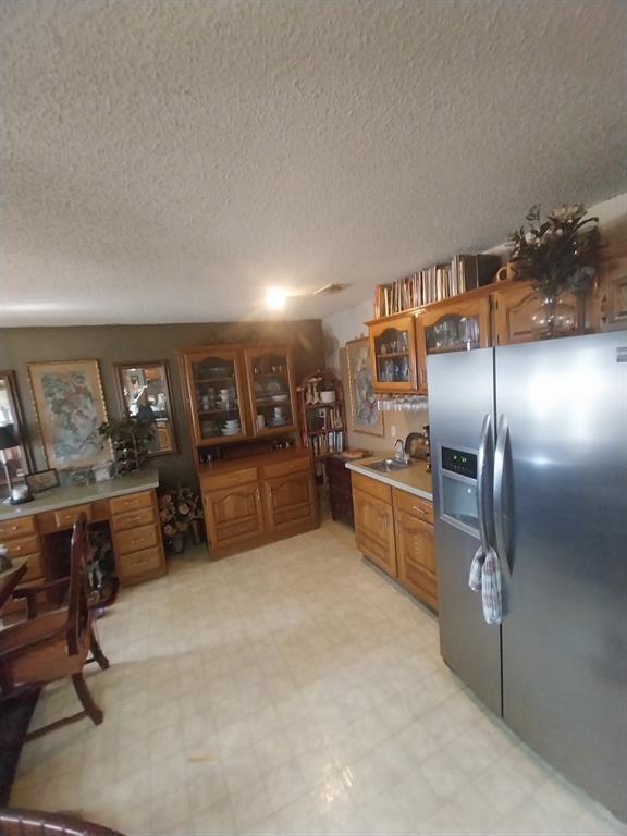 4415 Smallwood Road Reno, TX 75462 - Photo 9 of 39 a kitchen with stainless steel appliances granite countertop a refrigerator and a stove