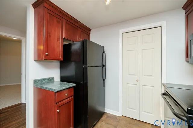 a kitchen with stainless steel appliances granite countertop a refrigerator and a stove top oven