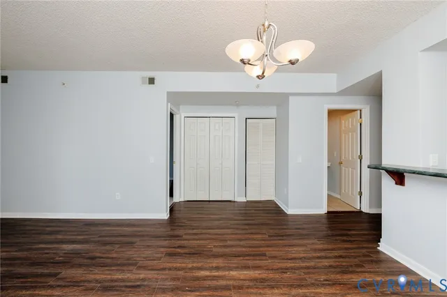 a view of a room with wooden floor