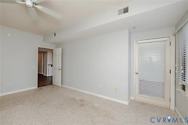 a view of an empty room with closet area