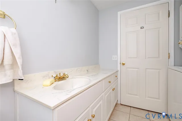 a bathroom with a sink a vanity and a shower curtain