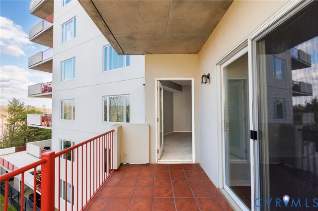 a view of a balcony with wooden floor and fence