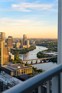 a view of a kitchen with kitchen island a large window a sink and a counter top space