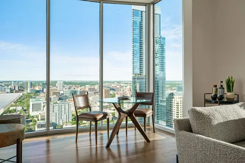 a view of a city from a dining room with a table