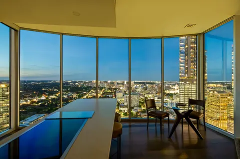 a view of a hallway with wooden floor and glass door