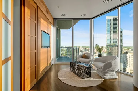 a living room with furniture a window and a glass door