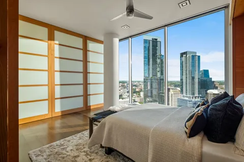 a bathroom with a granite countertop sink a mirror and shower