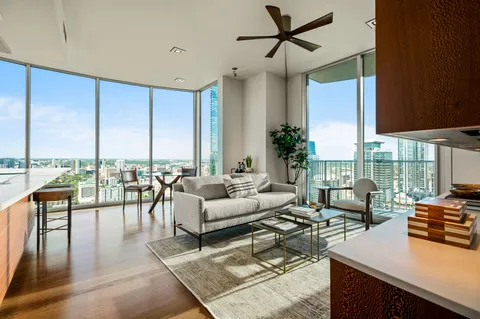 a living room with furniture and a floor to ceiling window