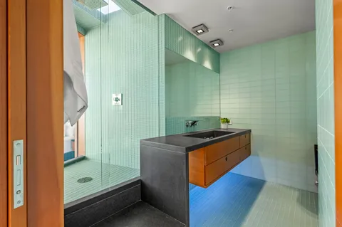 a bathroom with a granite countertop sink and a mirror